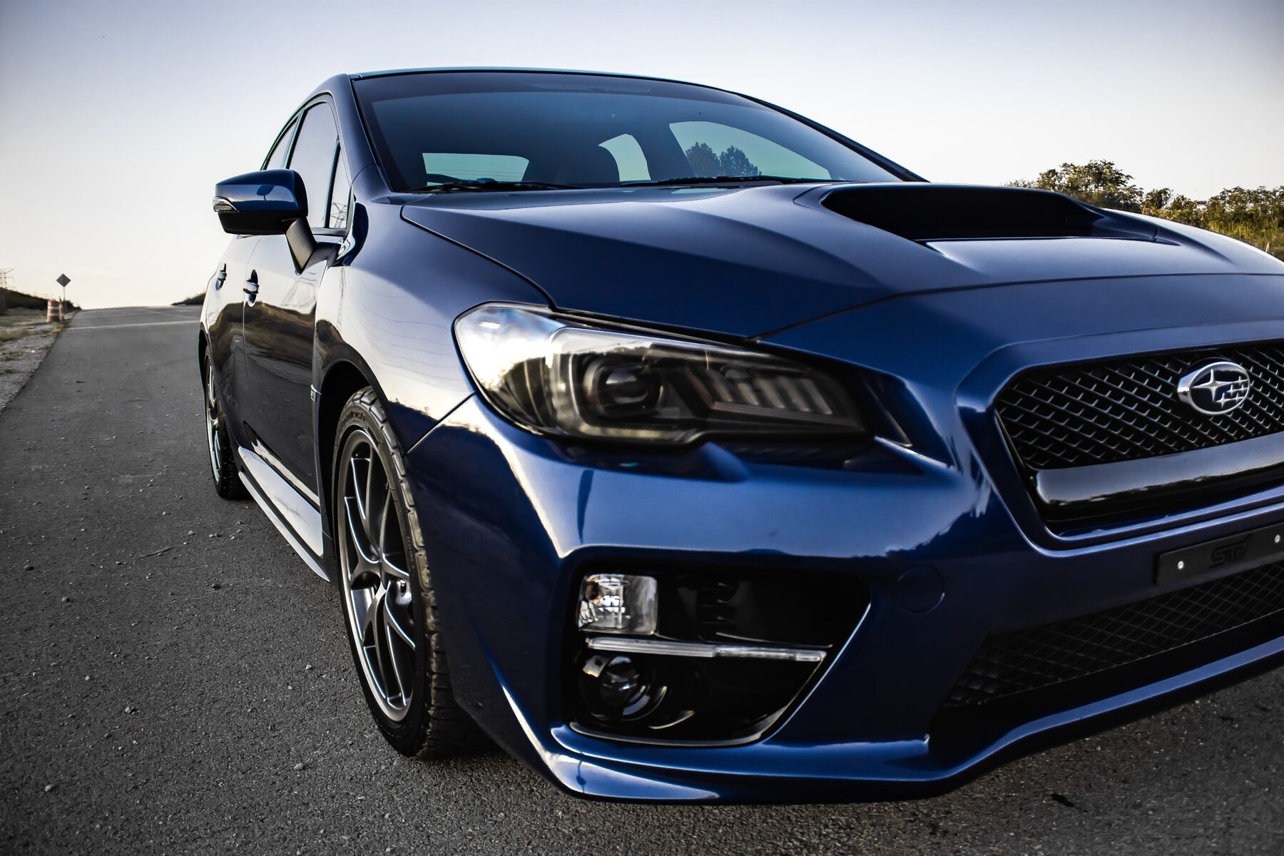 Blue Subaru WRX STI parked on a road