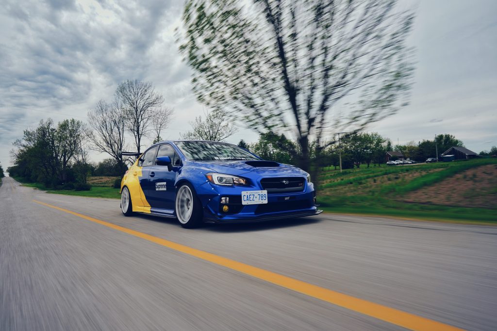 2017 Subaru WRX with intake installed speeding down road