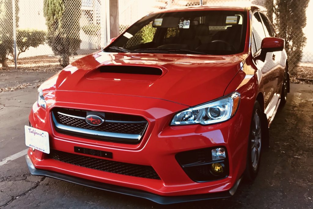 Red 2017 Subaru WRX from the front, with a polyurethane front lip