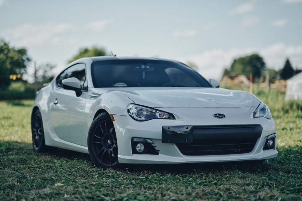 white Subaru BRZ lowered on coilovers in grass